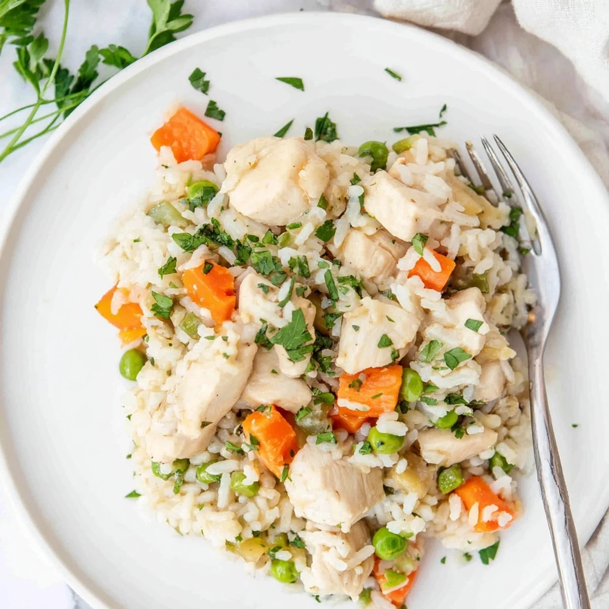 Comforting Instant Pot chicken and rice recipe steaming hot with tender meat and vibrant peas