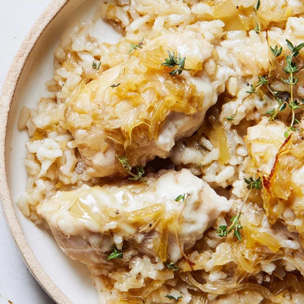 Golden brown chicken breasts nestled in creamy French onion chicken rice with melted Gruyère cheese topping