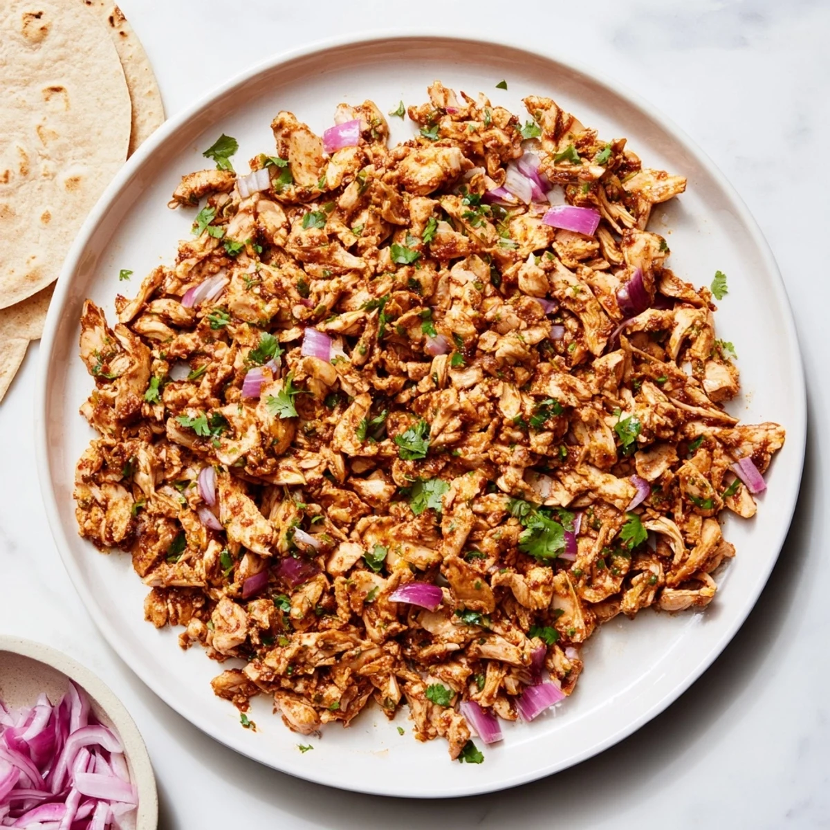 Savory mushroom carnitas topped with fresh cilantro and diced red onion