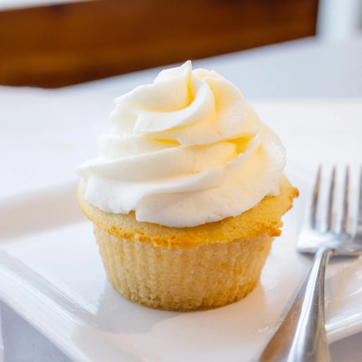 Light and fluffy vanilla cupcakes with swirls of creamy vanilla buttercream frosting