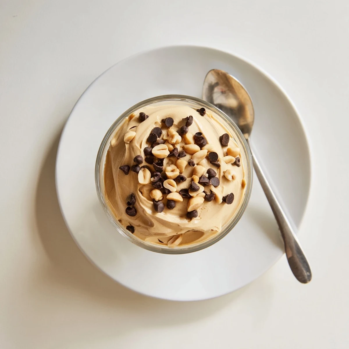 Fluffy peanut butter mousse dessert with whipped topping and garnish of chopped roasted peanuts