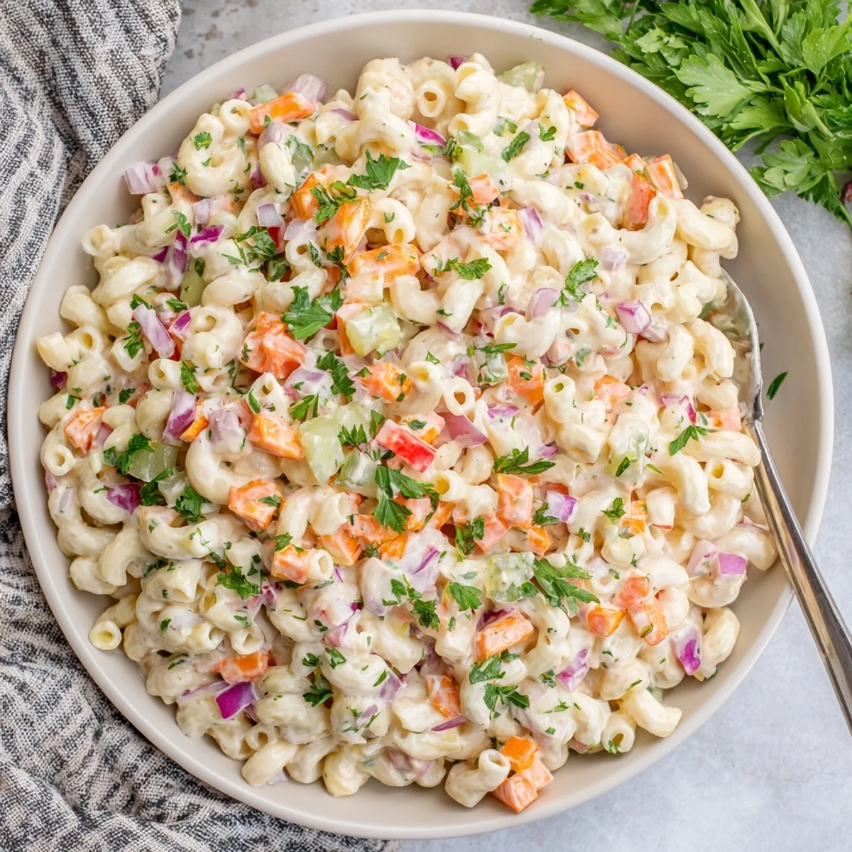 Chilled macaroni salad side dish with vibrant vegetables coated in smooth tangy mayonnaise dressing for summer barbecues
