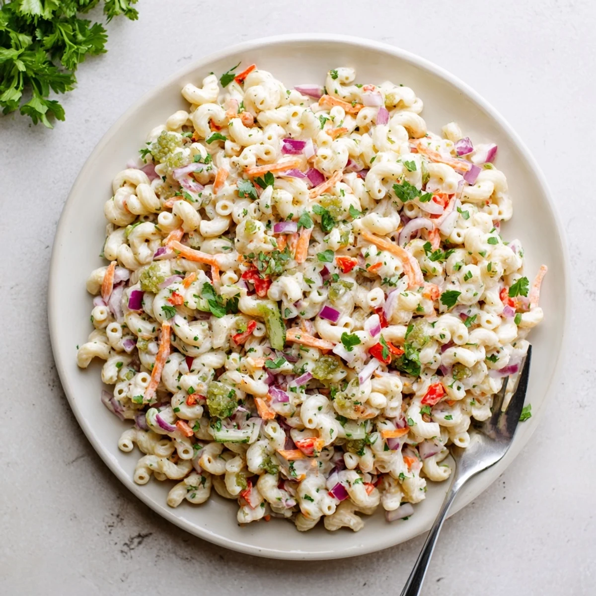 Classic American macaroni salad featuring tender pasta tossed in tangy creamy dressing with crunchy red bell peppers and celery