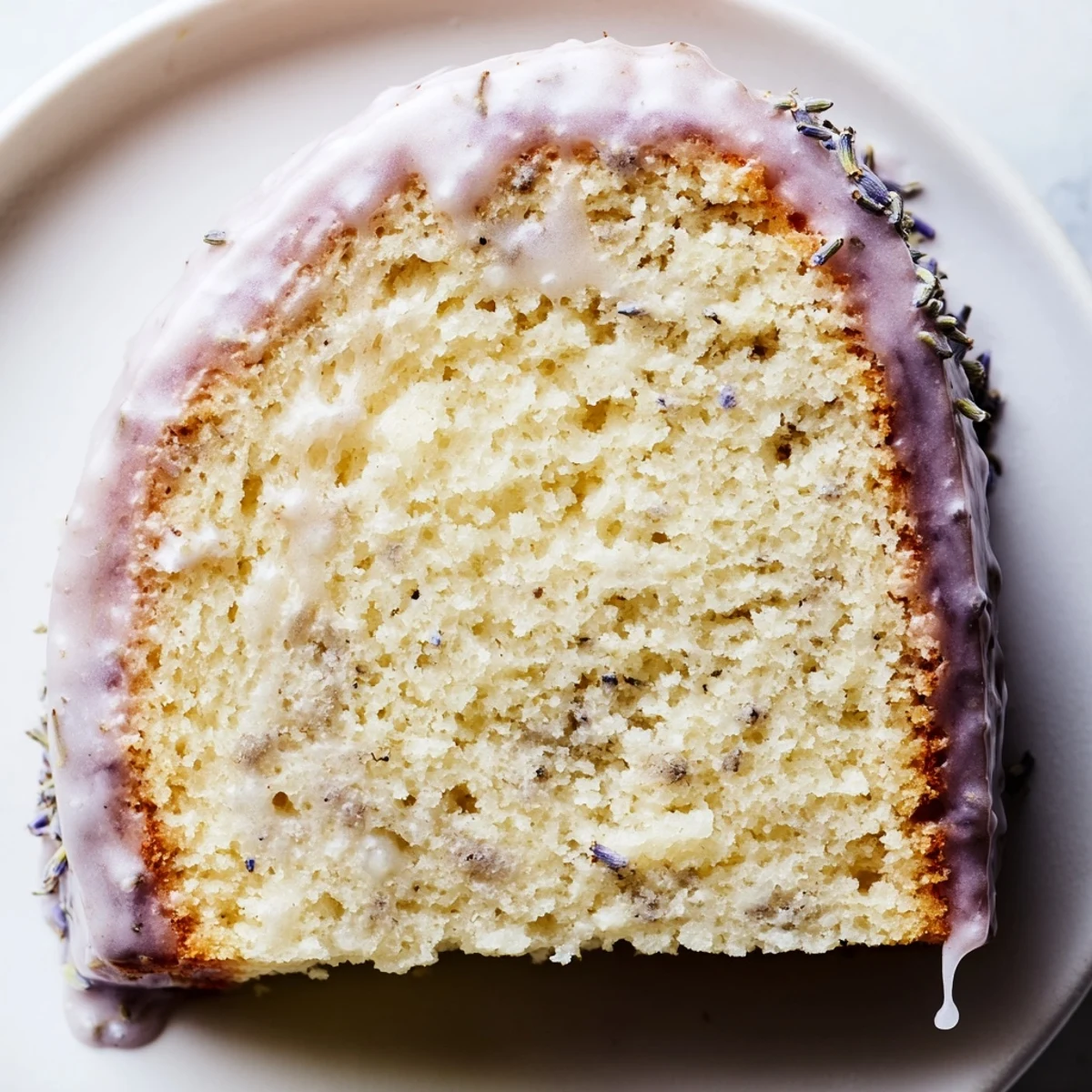 Lavender cake with lemon glaze drizzled over a tender golden crumb