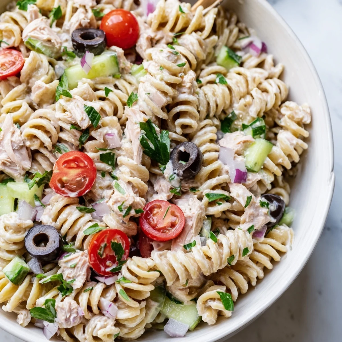 Creamy tuna pasta salad in a bowl with crisp vegetables and tangy dressing