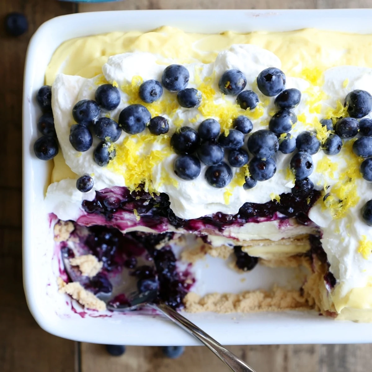 Thick slices of lemon blueberry lasagna showing layered cream and berry swirls