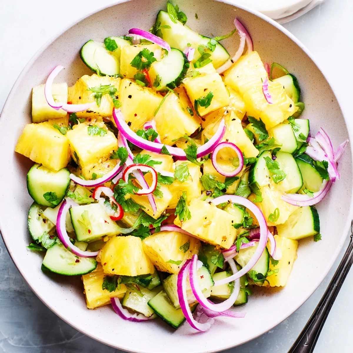 Pineapple Cucumber Salad with fresh diced pineapple, crisp cucumber, zesty lime dressing
