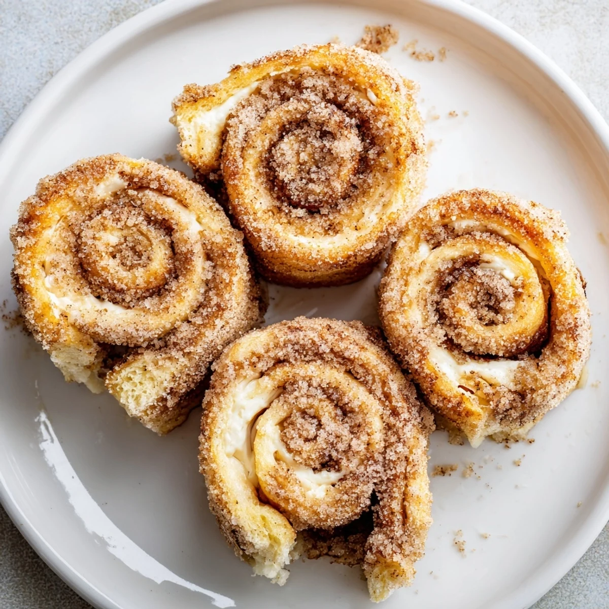 Warm, golden Cinnamon Roll French Toast Roll Ups with gooey cream cheese center