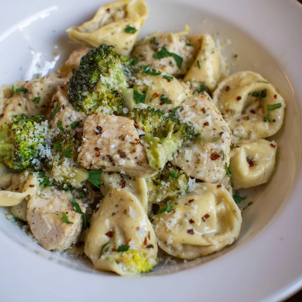 Creamy Garlic Parmesan Tortellini Chicken Broccoli Recipe steaming on plate, tender chicken, saucy pasta