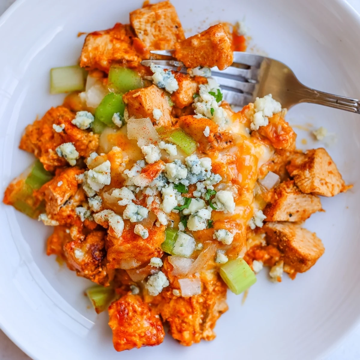 Keto Buffalo Chicken Skillet sizzling with creamy sauce, melted mozzarella, bright parsley garnish