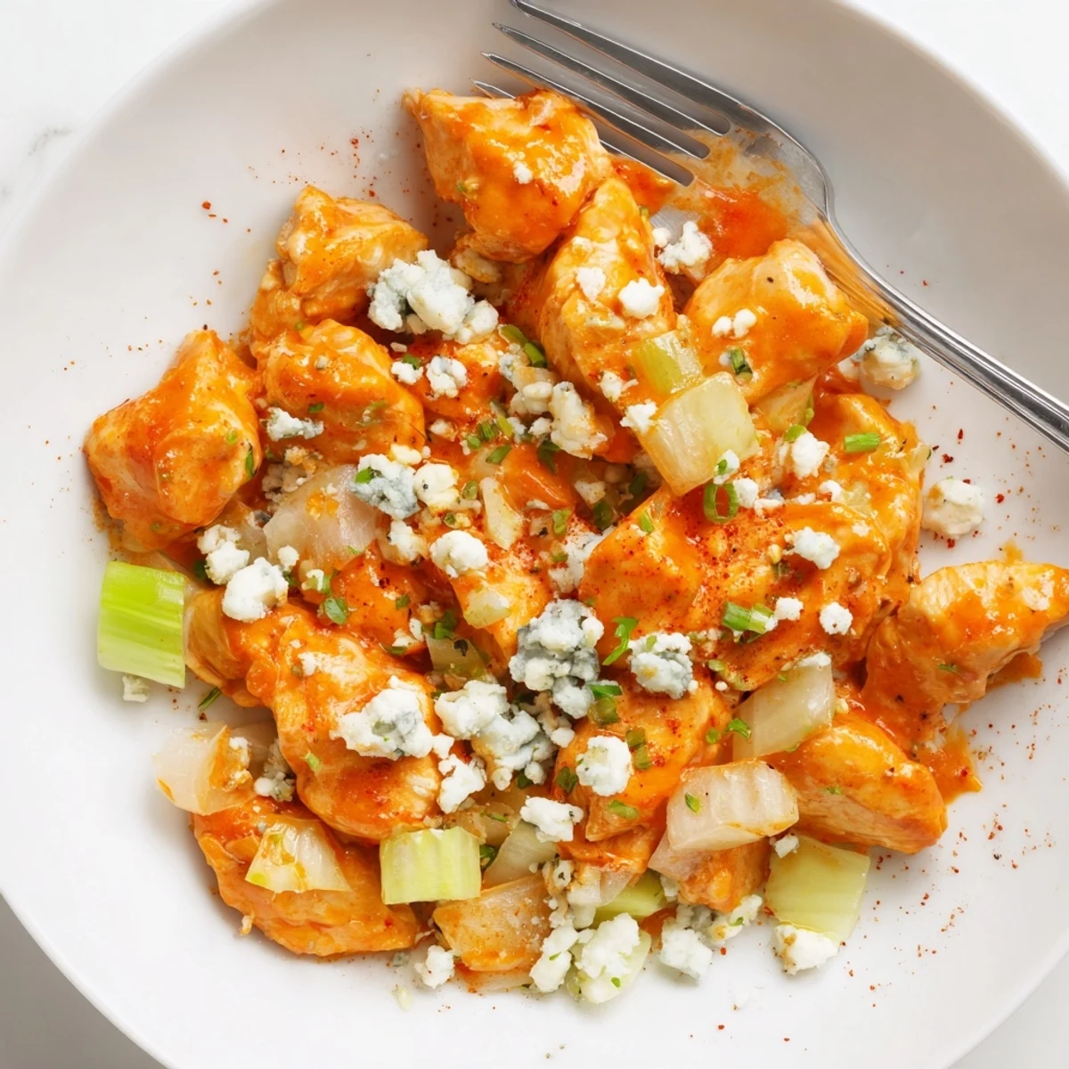 A hot, one pan Keto Buffalo Chicken Skillet topped with crumbled blue cheese