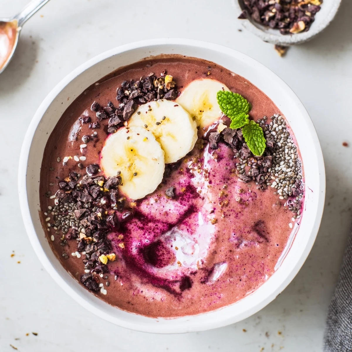 Vibrant pink-hued Chocolate Beet Smoothie topped with dark chocolate shavings, chilled