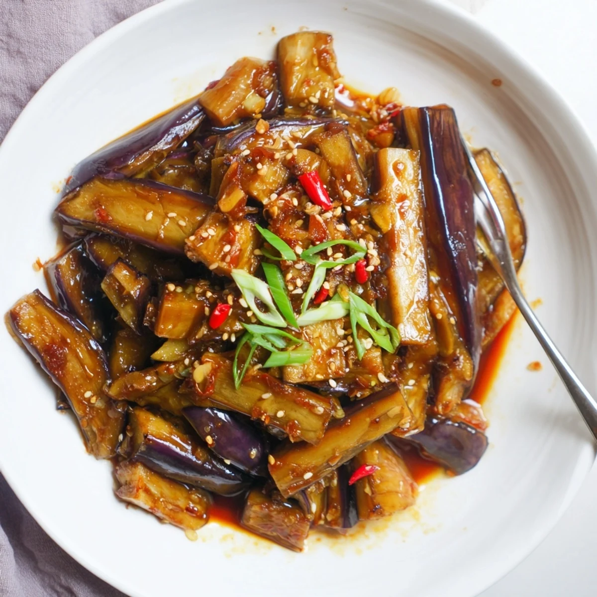 Steaming Sichuan Style Braised Aubergines in a wok, fragrant and ready to serve
