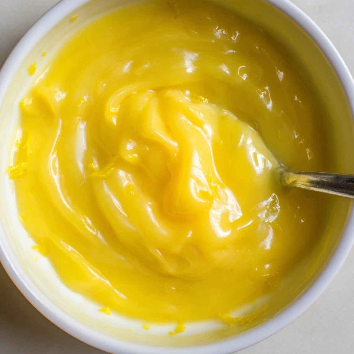 Lemon Curd Recipe: glossy golden spread on warm scone, citrus aroma.