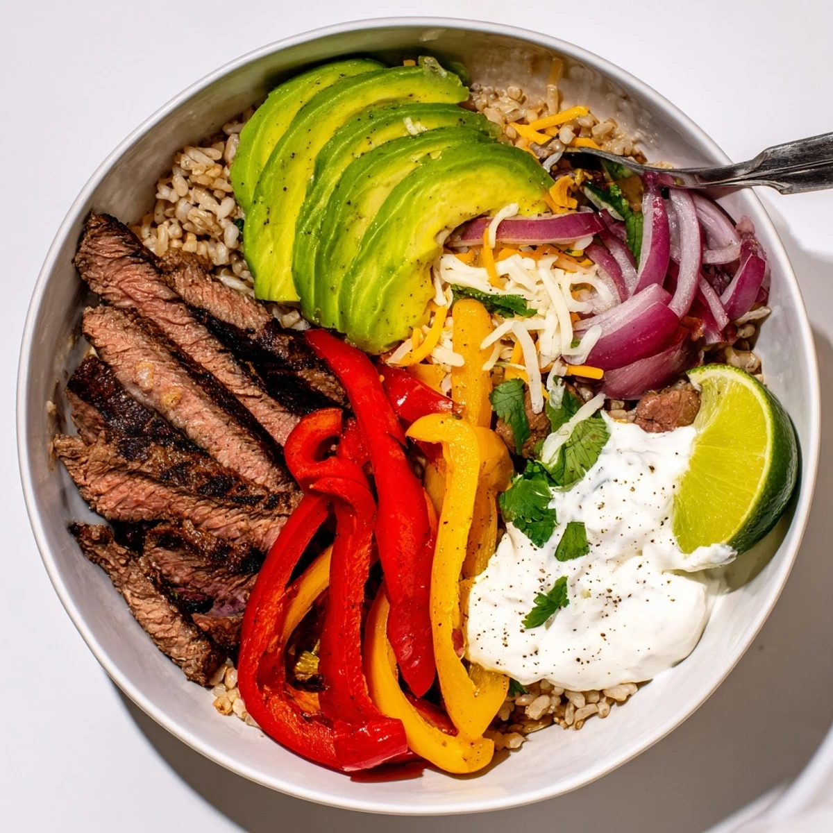 Steak Fajita Power Bowls with sizzling steak, charred peppers, avocado slices