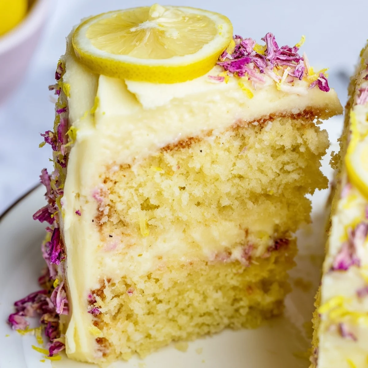 Two-tier lemon birthday cake with zesty citrus decoration and smooth tangy frosting on a serving plate