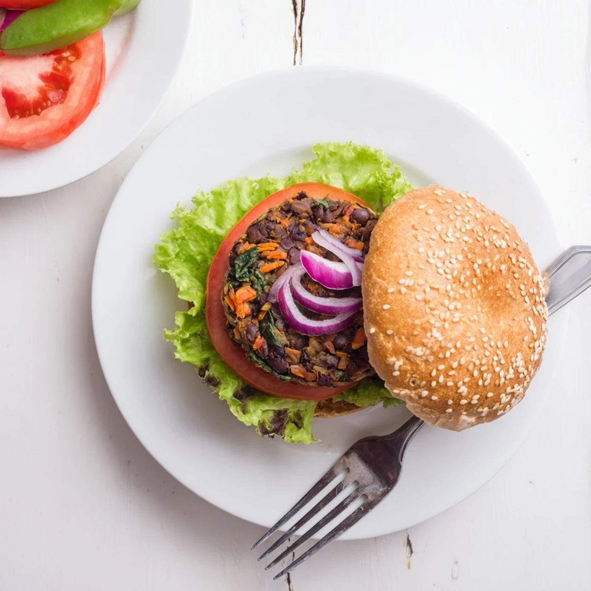 Hearty homemade veggie burgers sizzling in skillet with perfectly crisp edges and vibrant vegetable specks visible throughout