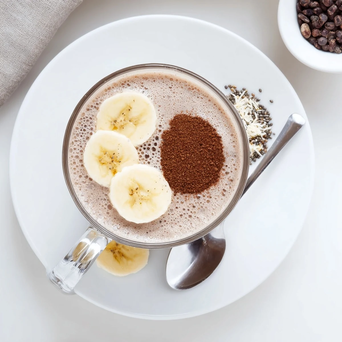 Frosty Raw Chocolate Banana Shake blended smooth with almond milk, perfect breakfast