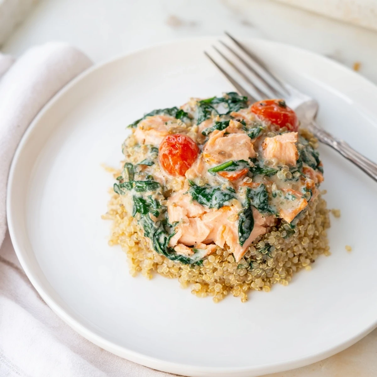 Healthy leftover salmon recipe plated with quinoa and fresh chives for a satisfying dinner  