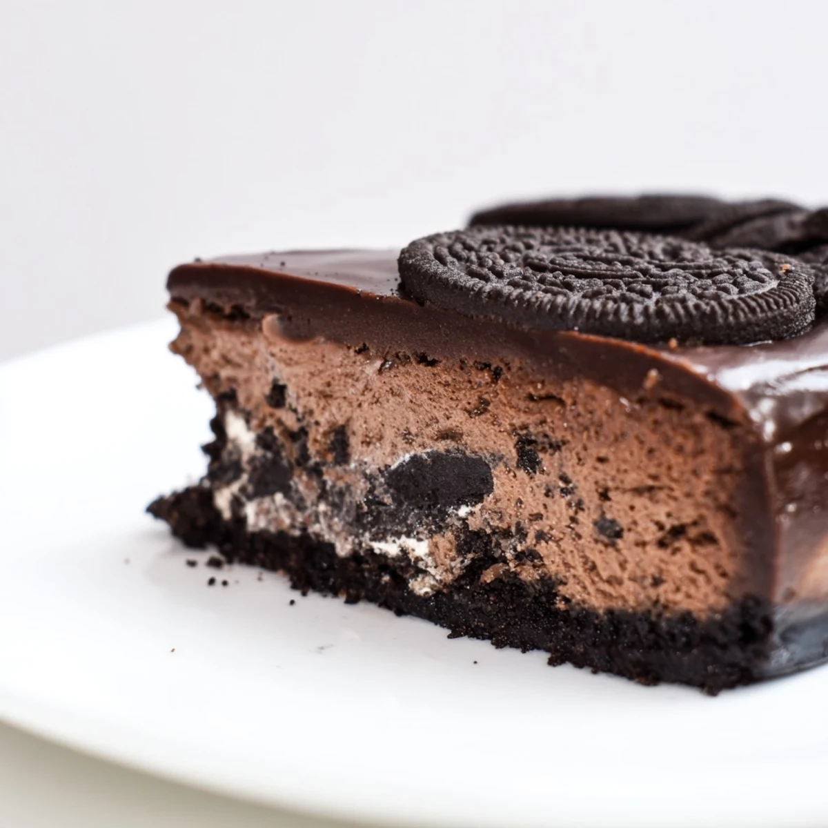 Rich Oreo chocolate cheesecake featuring a crunchy Oreo crust, velvety filling, and luscious ganache topping.  