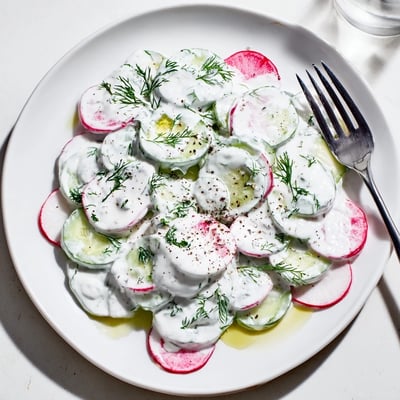 Crisp sliced cucumbers and peppery radishes coated in tangy yogurt dill dressing