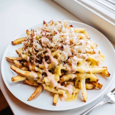 Animal Style Fries smothered in gooey cheese, sweet onions, and tangy pink sauce